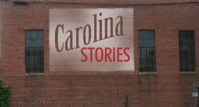 Carolina Stories logo on brick wall
